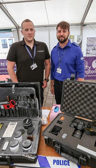Police stall with photography equipment and two officers