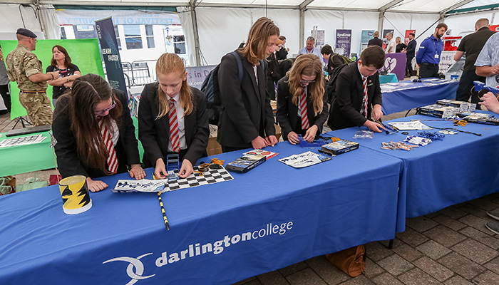 School children looking at the College stand